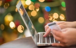 Person entering credit card information on computer